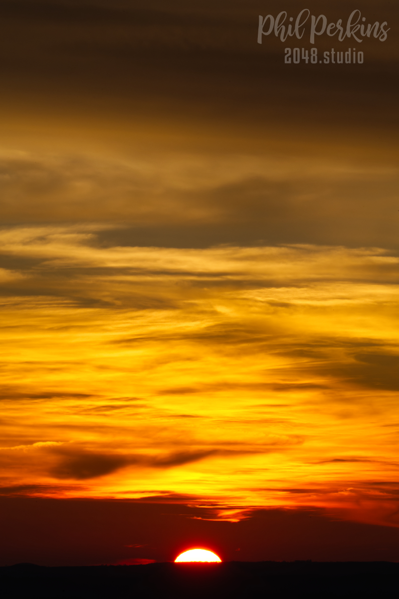 Fiery Sunset Over Horizon