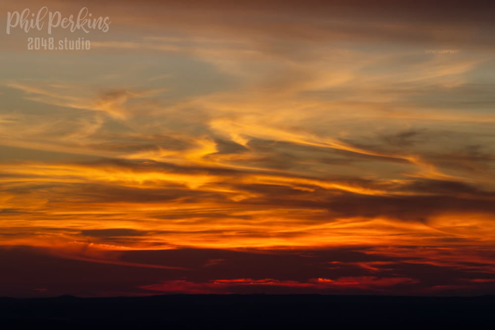 Fiery Sunset Over Horizon
